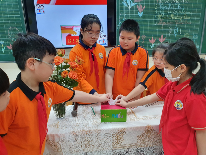 A picture containing text, person, orange, work-clothing

Description automatically generated