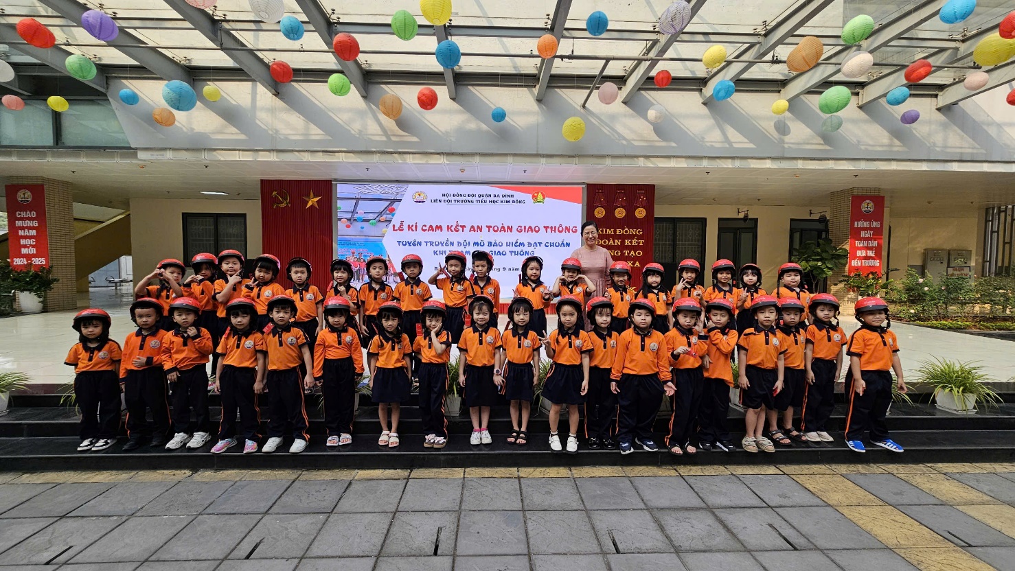 A group of children in orange shirts

Description automatically generated