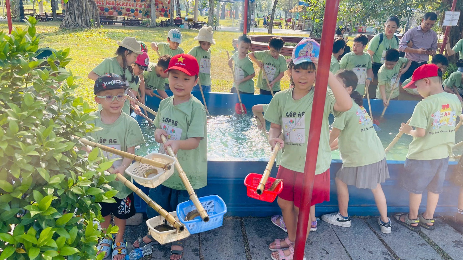 A group of children in green shirts
Description automatically generated