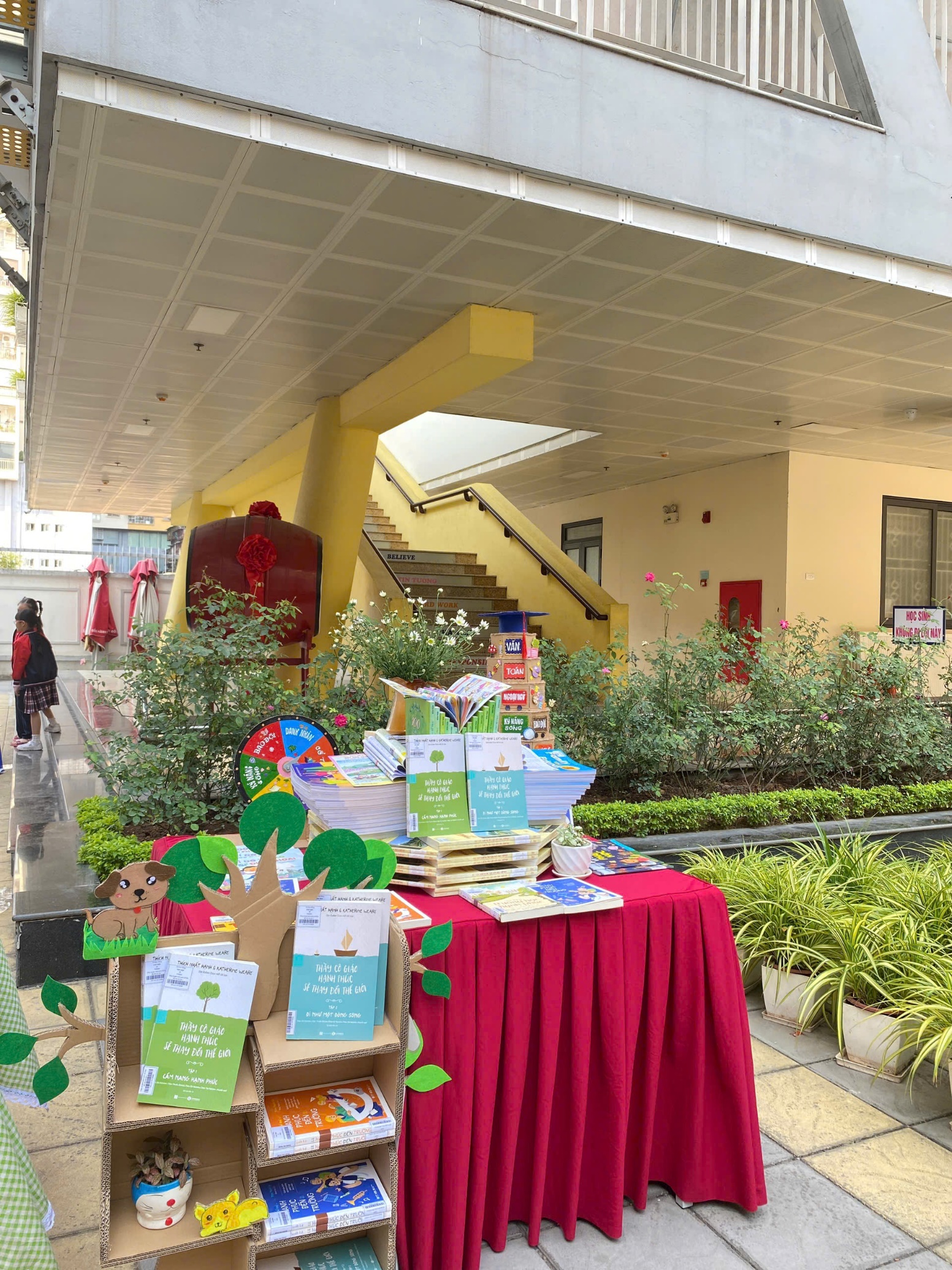 A table with red cloth and books on itDescription automatically generated