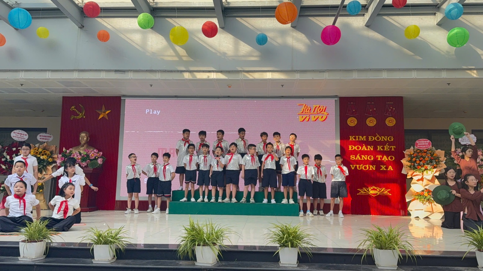 A group of children on a stageDescription automatically generated