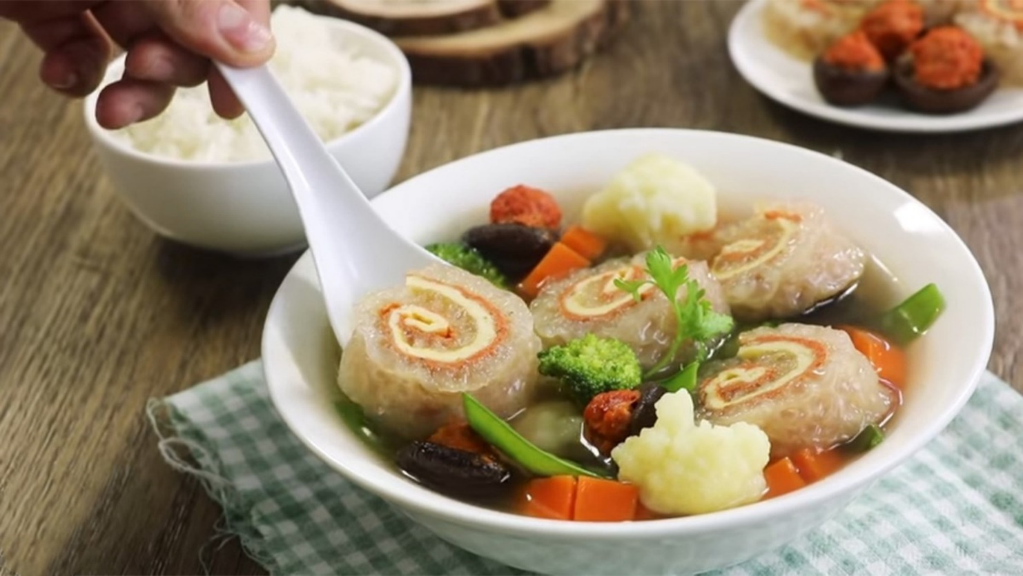 A bowl of soup with food in it

AI-generated content may be incorrect.