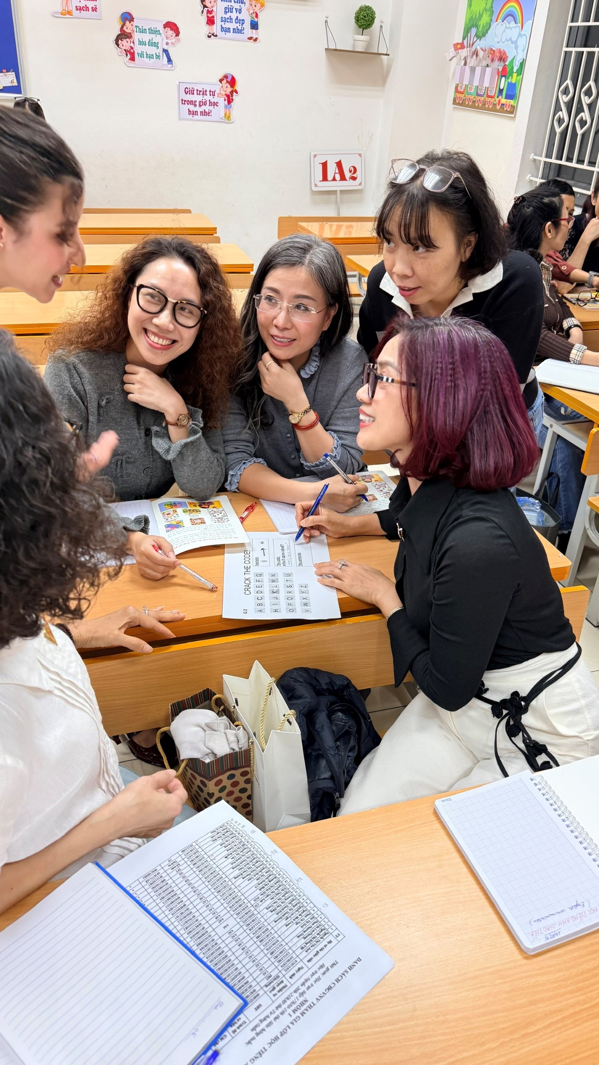 A group of women sitting at desks
AI-generated content may be incorrect.