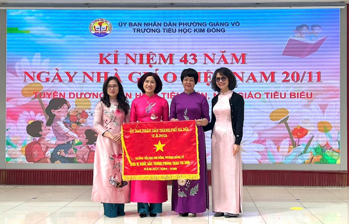 A group of women standing in front of a large banner

AI-generated content may be incorrect.