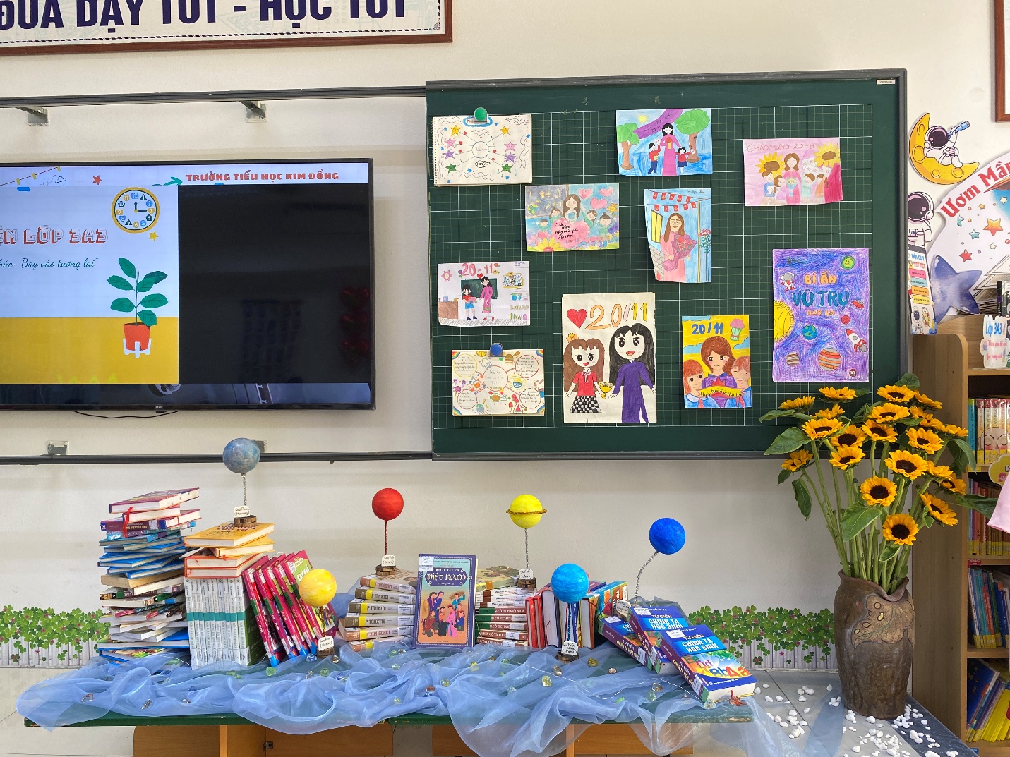A table with books and flowers on it
Description automatically generated