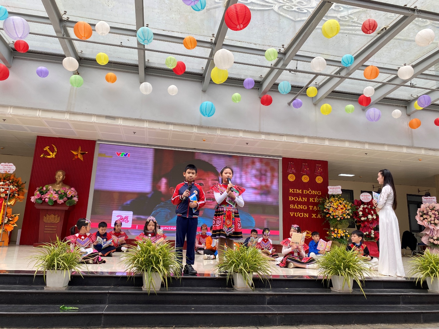 A group of children on a stage
Description automatically generated