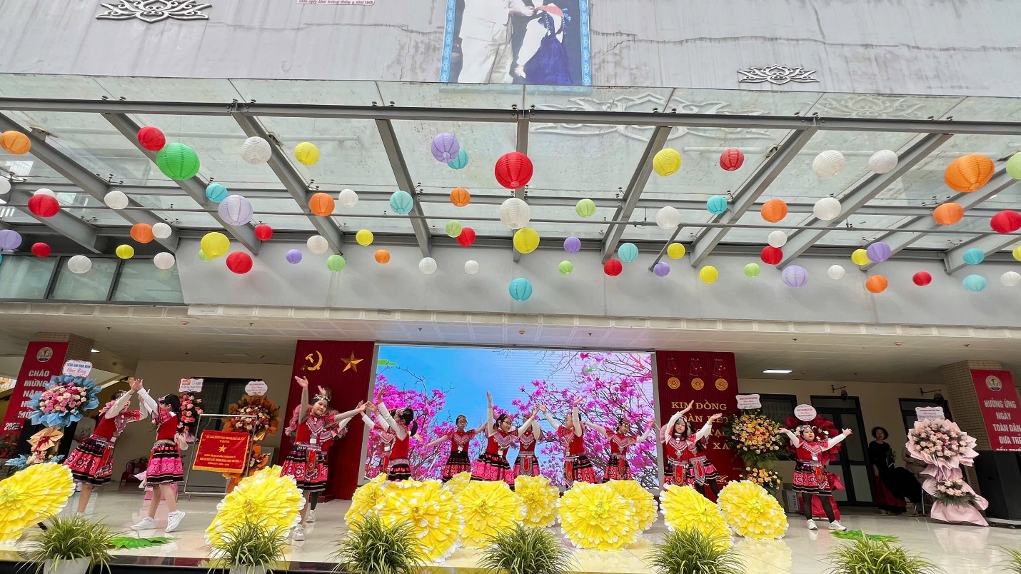 A group of people dancing on a stage
Description automatically generated