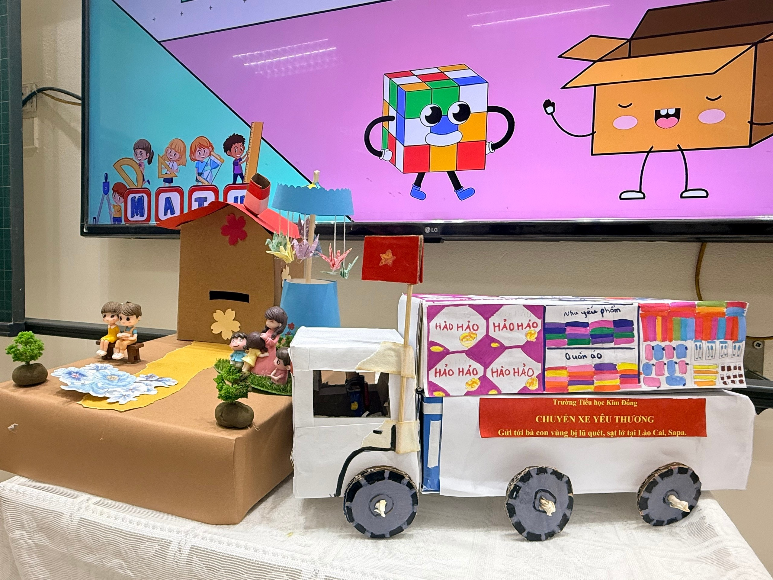 A group of boxes with a truck and a toy house
Description automatically generated with medium confidence