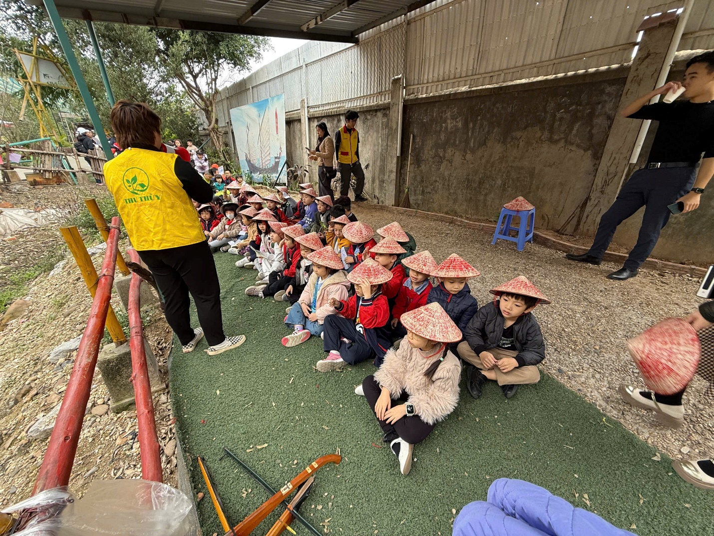 A group of children sitting on the ground
AI-generated content may be incorrect.