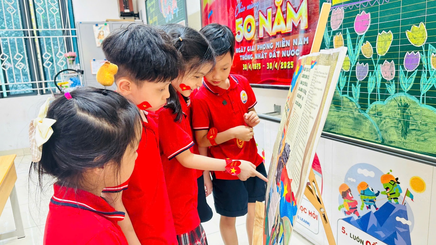 A group of children looking at a piece of paper
Description automatically generated