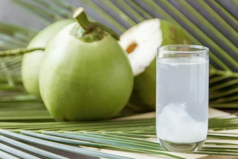 A glass of coconut water next to coconuts
AI-generated content may be incorrect.