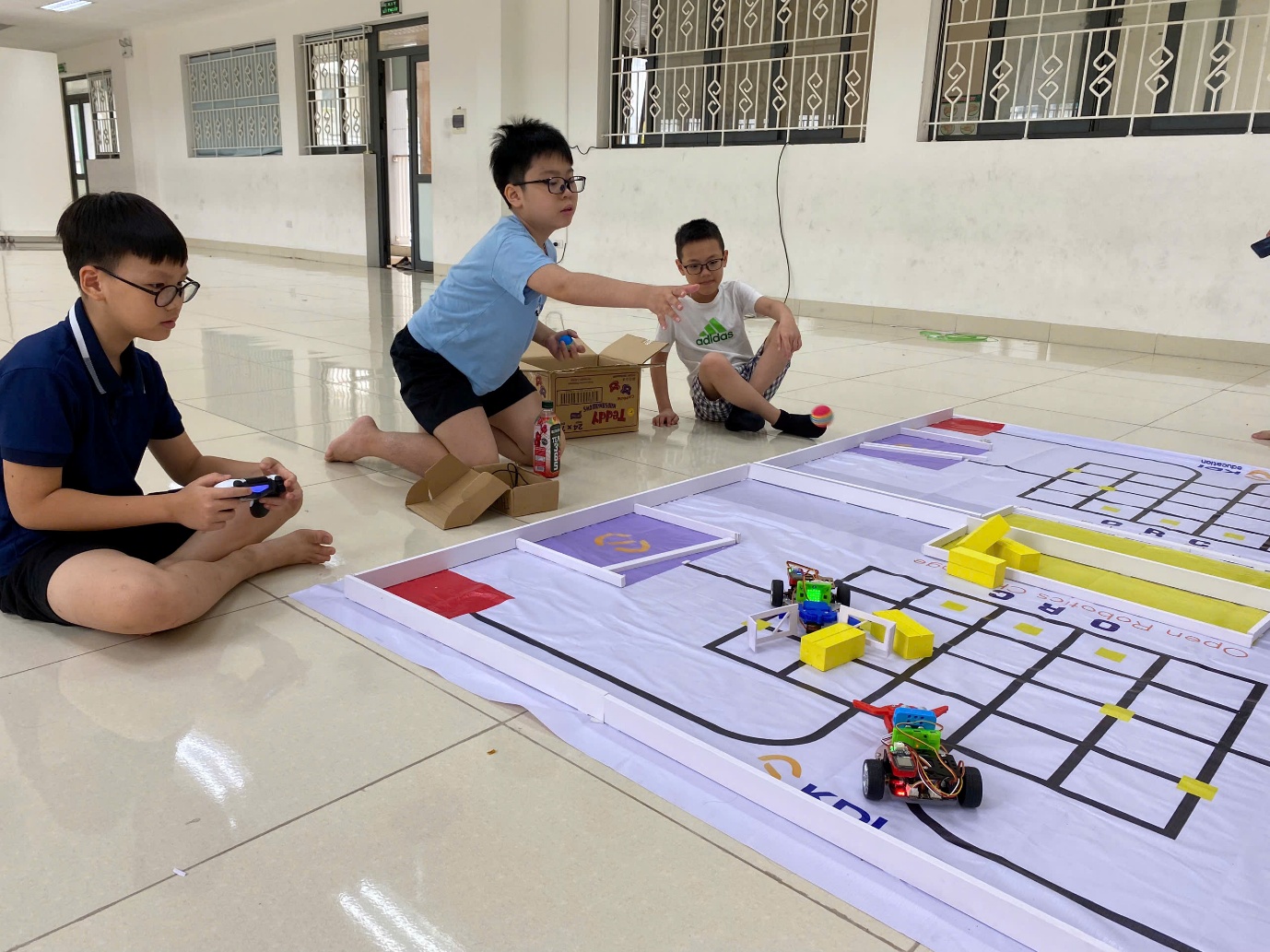A group of kids playing with a large paper game
AI-generated content may be incorrect.