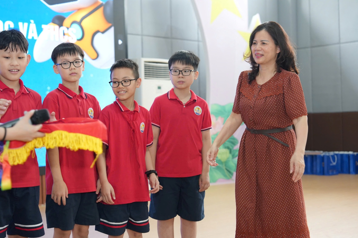 A person standing next to a group of boysAI-generated content may be incorrect.