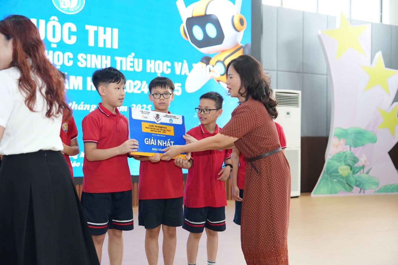 A person holding a box with a group of childrenAI-generated content may be incorrect.