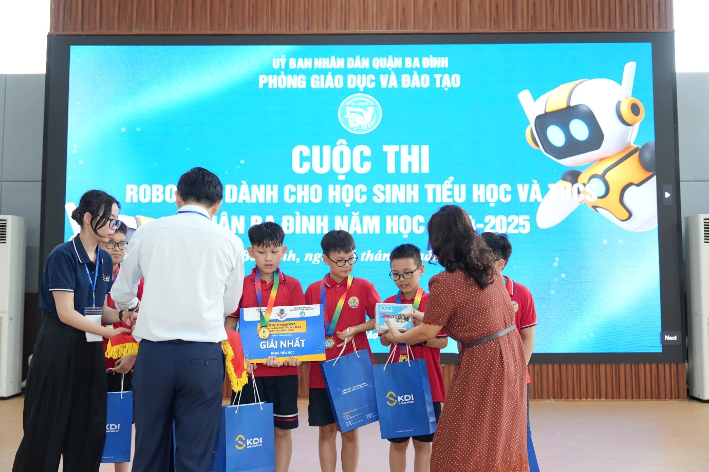 A group of people standing in front of a large screenAI-generated content may be incorrect.