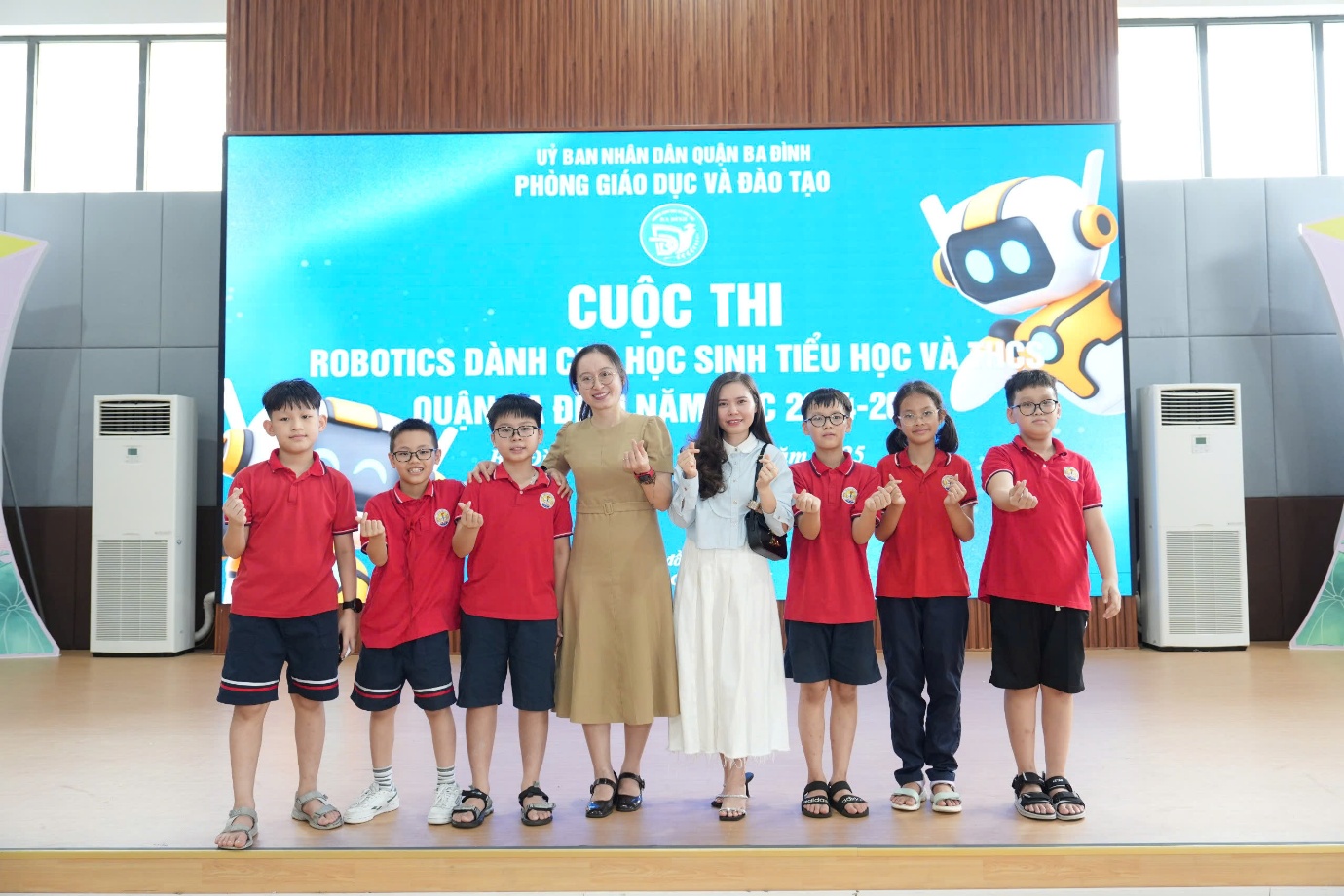 A group of children standing on a stageAI-generated content may be incorrect.