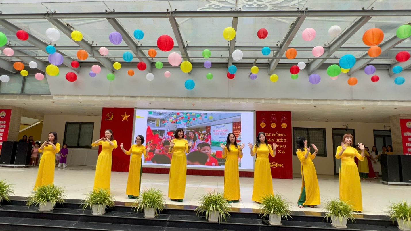 A group of women in yellow dresses performing on a stage
AI-generated content may be incorrect.