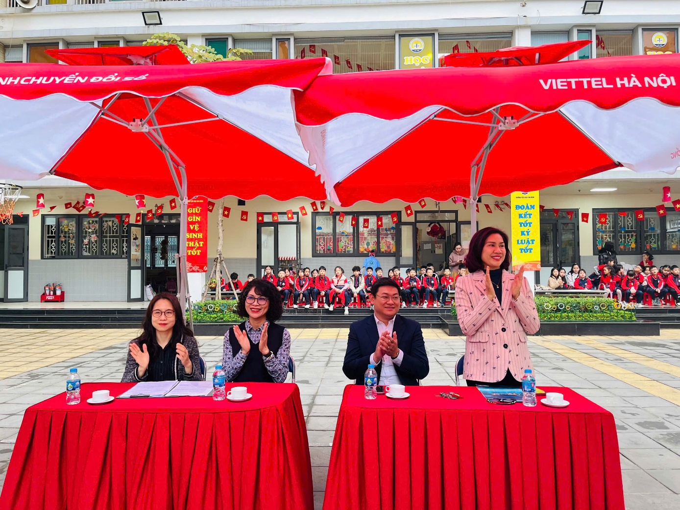 A group of people standing under umbrellas

Description automatically generated
