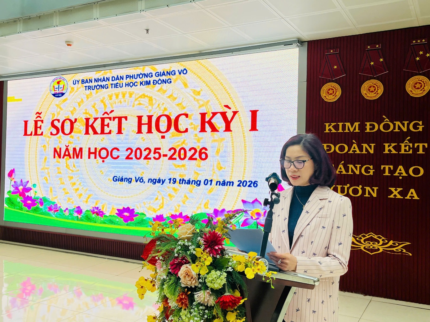 A person standing at a podium

Description automatically generated