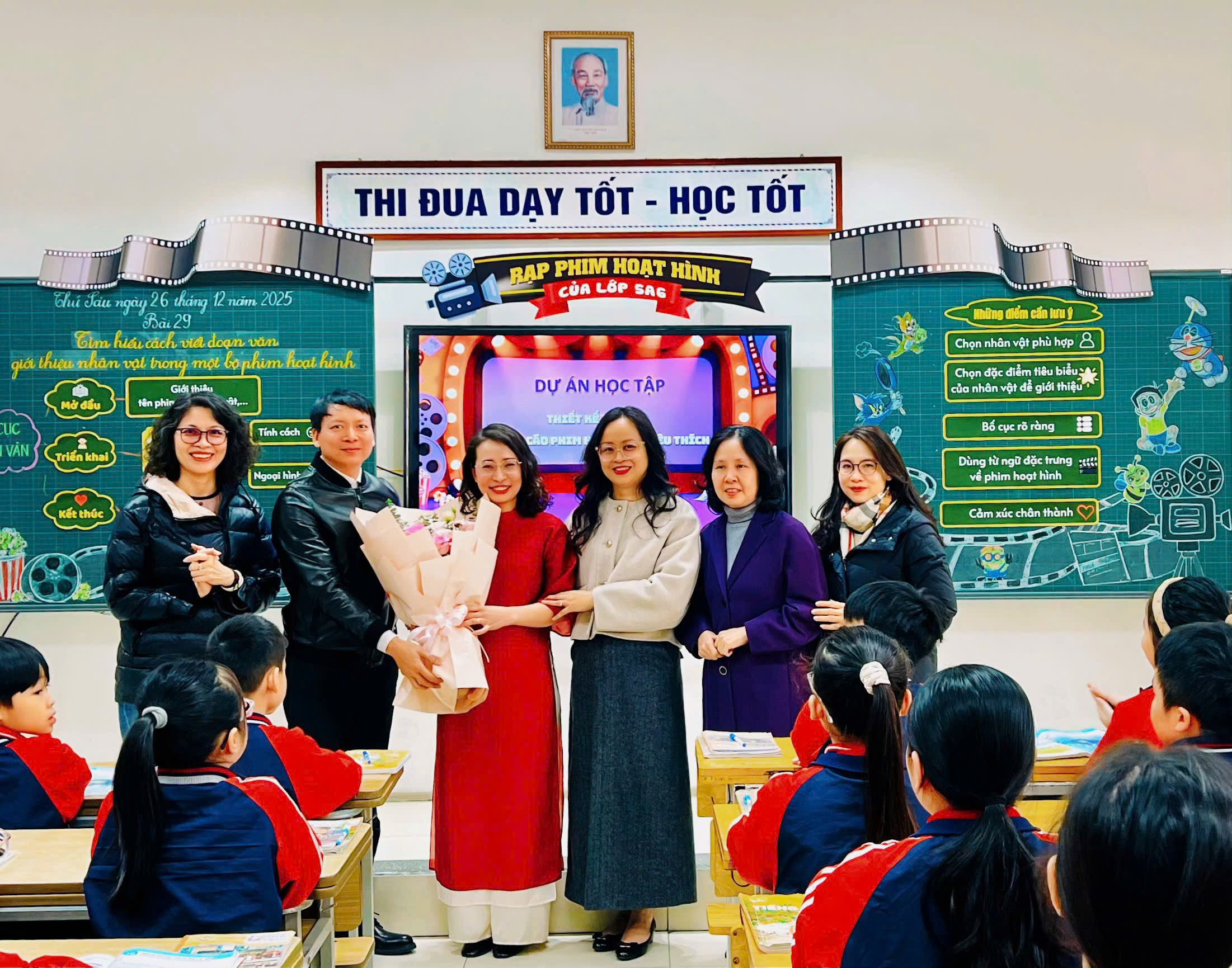 A group of people standing in a classroom

Description automatically generated