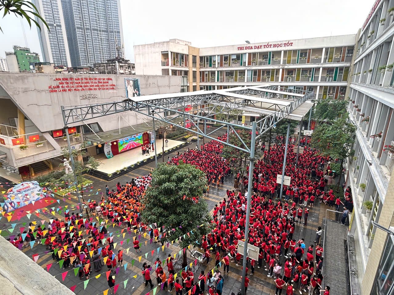 A group of people in red shirts

Description automatically generated